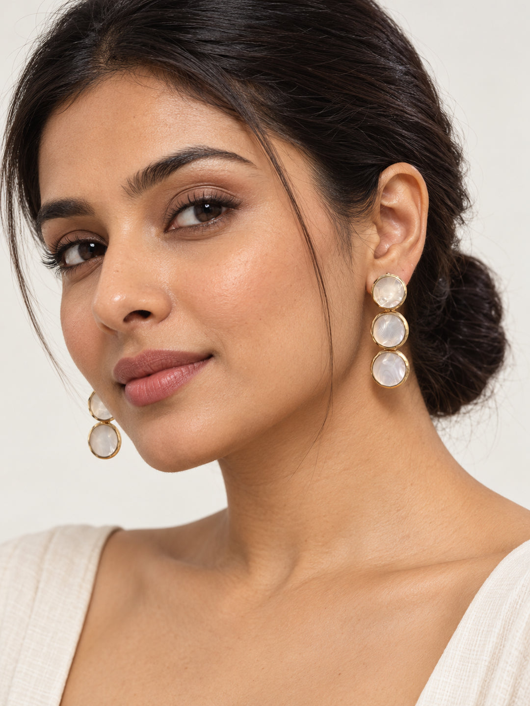 ELVION White Triple Disc Earrings — Model wearing product