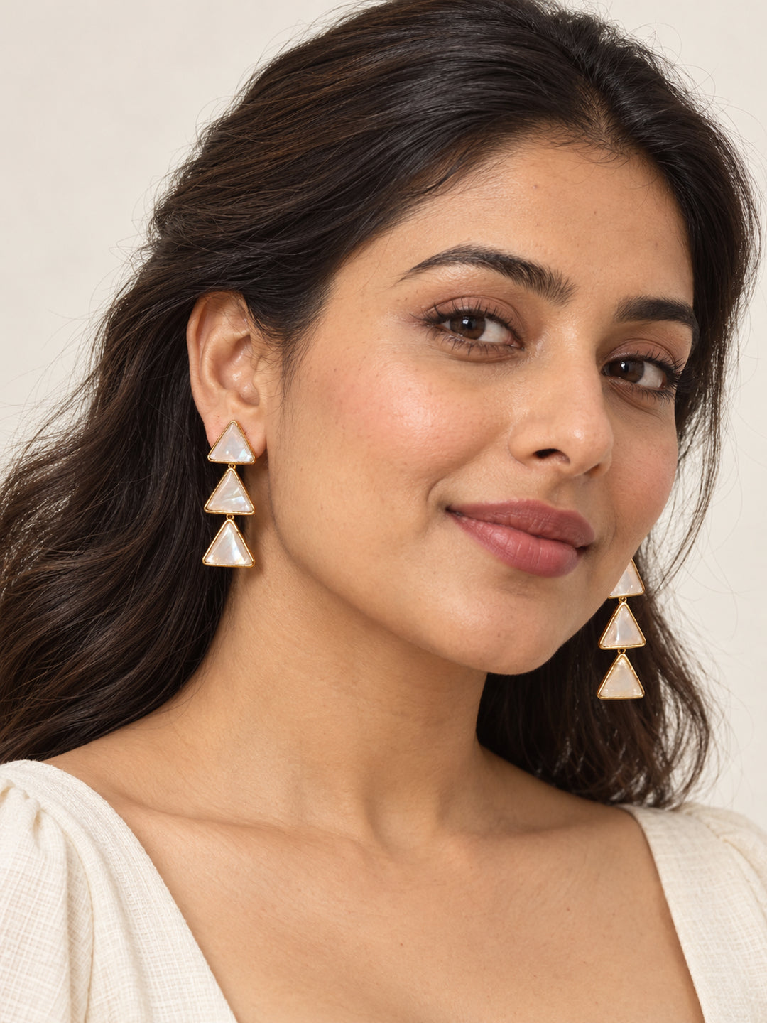 ELVION White Triangle Drop Earrings — Model wearing product